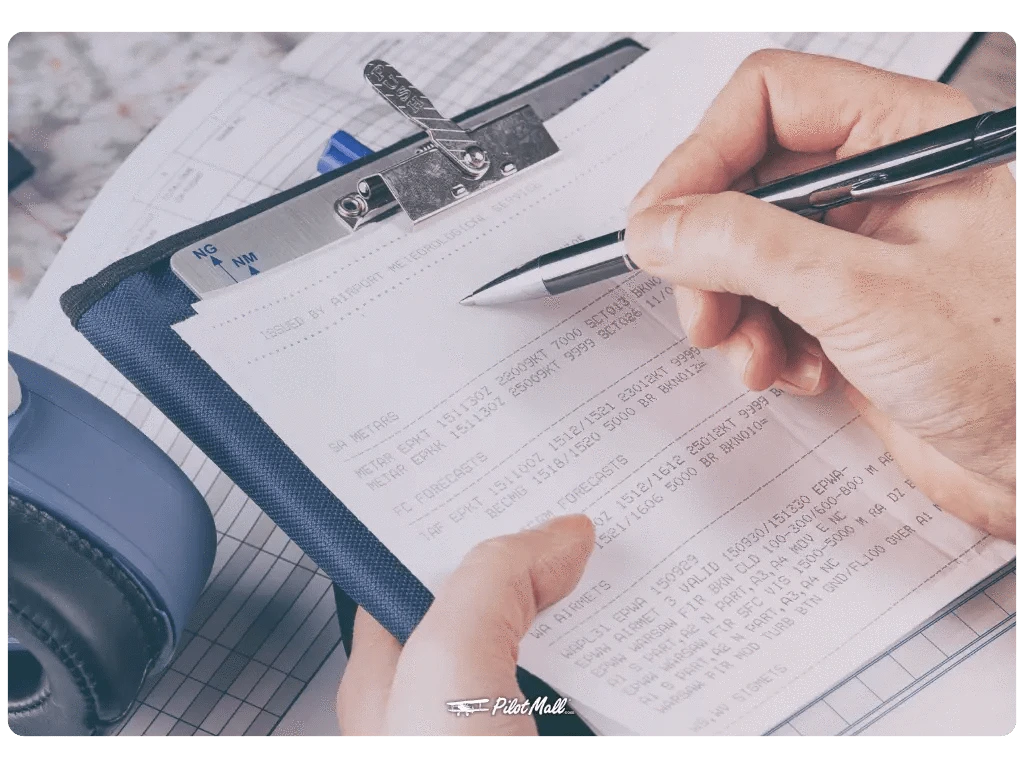 Pilot using a kneeboard for flight planning